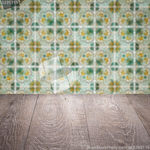 Image of Wood table top and blur vintage ceramic tile pattern wall