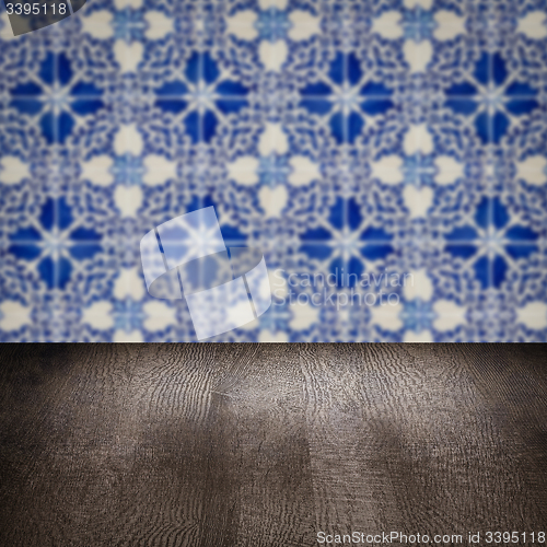 Image of Wood table top and blur vintage ceramic tile pattern wall