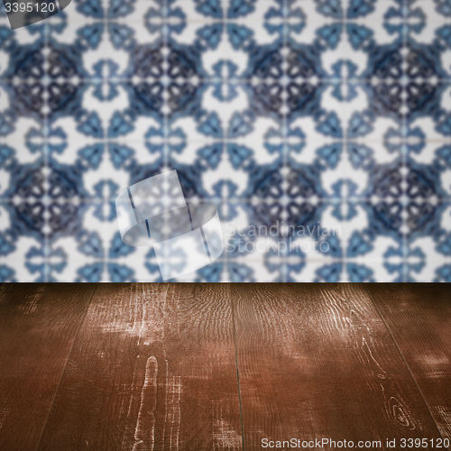 Image of Wood table top and blur vintage ceramic tile pattern wall