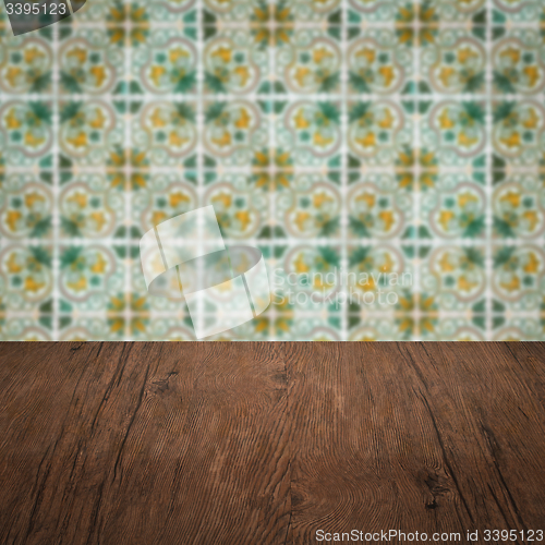 Image of Wood table top and blur vintage ceramic tile pattern wall
