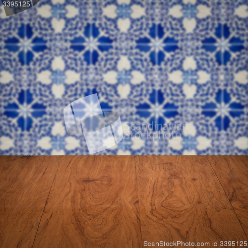 Image of Wood table top and blur vintage ceramic tile pattern wall