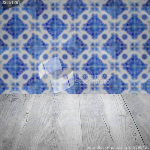 Image of Wood table top and blur vintage ceramic tile pattern wall