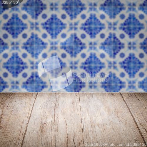 Image of Wood table top and blur vintage ceramic tile pattern wall