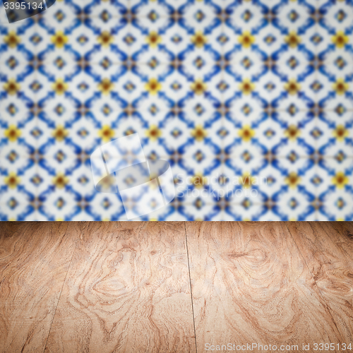 Image of Wood table top and blur vintage ceramic tile pattern wall