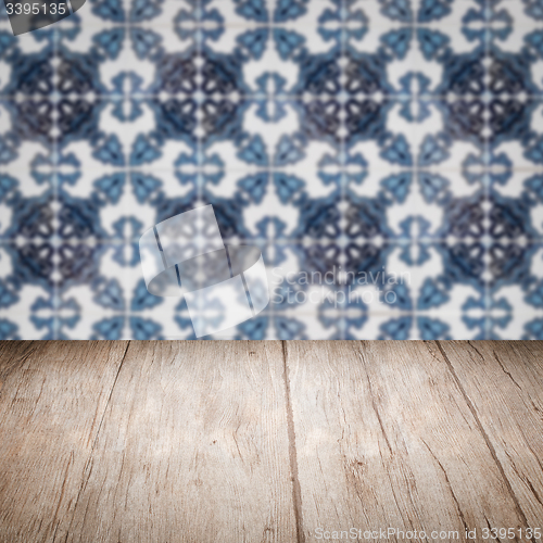 Image of Wood table top and blur vintage ceramic tile pattern wall