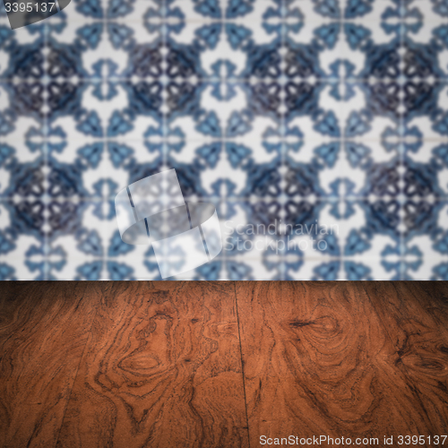 Image of Wood table top and blur vintage ceramic tile pattern wall