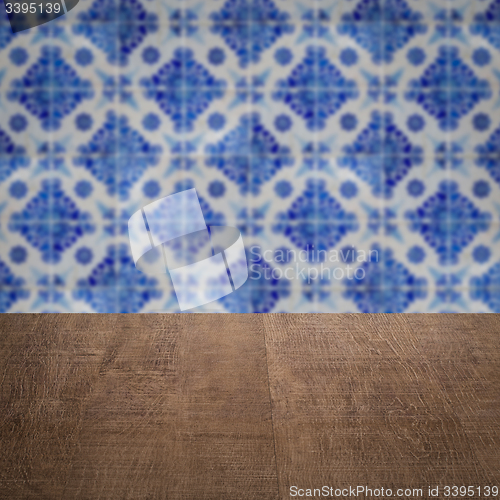 Image of Wood table top and blur vintage ceramic tile pattern wall