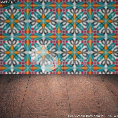 Image of Wood table top and blur vintage ceramic tile pattern wall