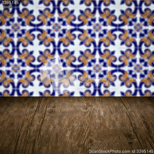 Image of Wood table top and blur vintage ceramic tile pattern wall