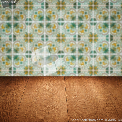 Image of Wood table top and blur vintage ceramic tile pattern wall