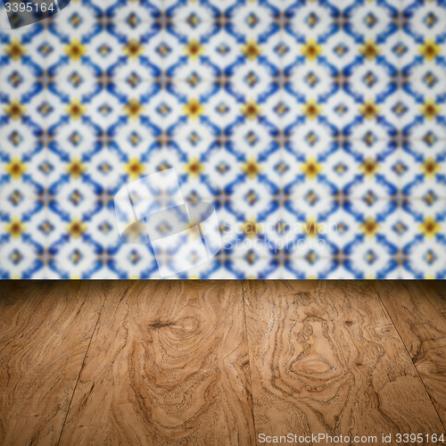 Image of Wood table top and blur vintage ceramic tile pattern wall