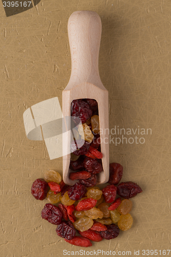 Image of Wooden scoop with mixed dried fruits