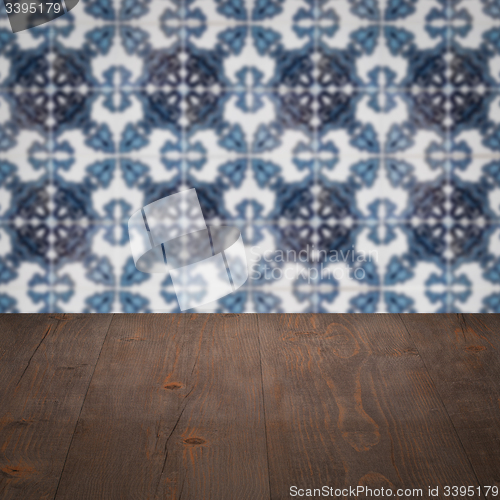 Image of Wood table top and blur vintage ceramic tile pattern wall