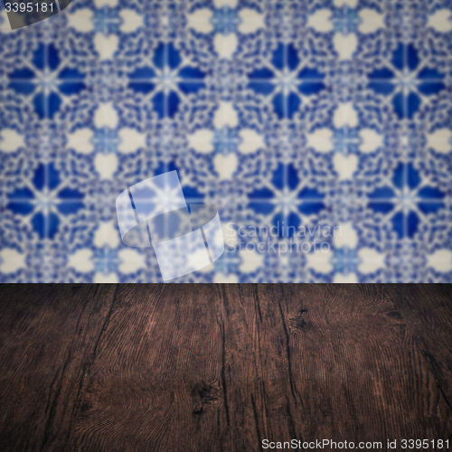 Image of Wood table top and blur vintage ceramic tile pattern wall