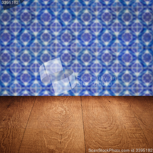 Image of Wood table top and blur vintage ceramic tile pattern wall