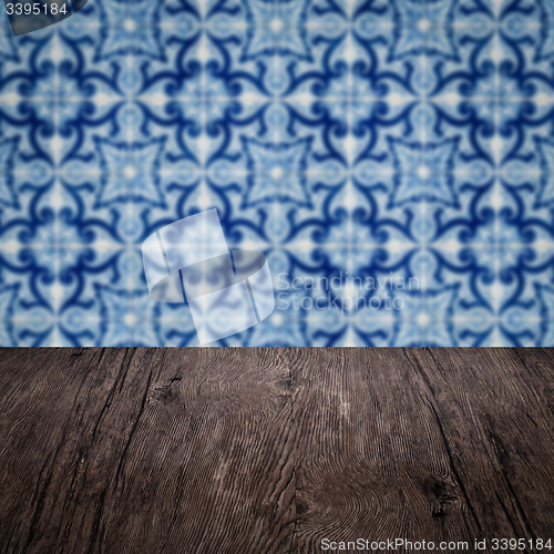 Image of Wood table top and blur vintage ceramic tile pattern wall