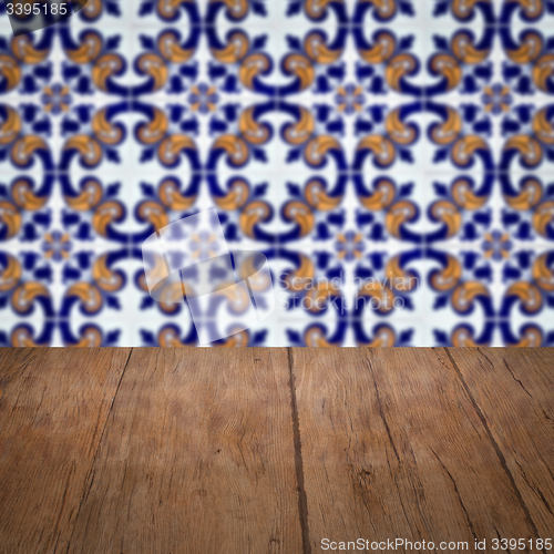 Image of Wood table top and blur vintage ceramic tile pattern wall