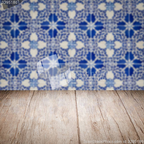 Image of Wood table top and blur vintage ceramic tile pattern wall