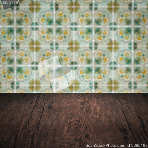 Image of Wood table top and blur vintage ceramic tile pattern wall