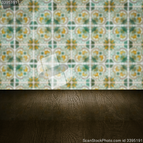 Image of Wood table top and blur vintage ceramic tile pattern wall