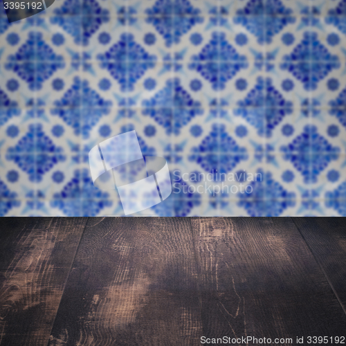 Image of Wood table top and blur vintage ceramic tile pattern wall