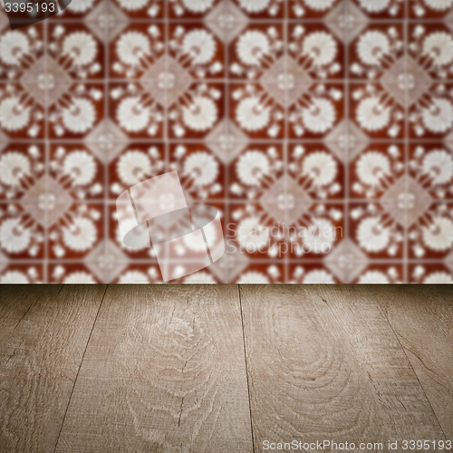 Image of Wood table top and blur vintage ceramic tile pattern wall