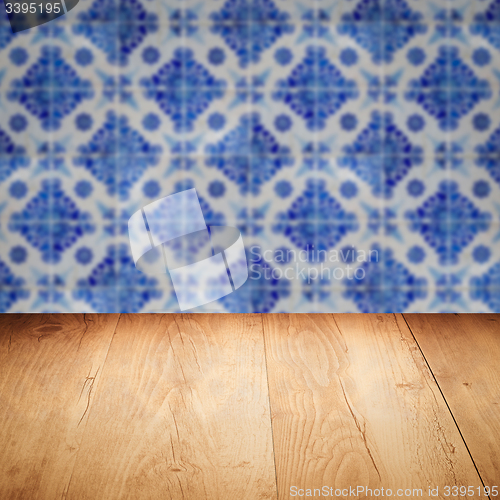 Image of Wood table top and blur vintage ceramic tile pattern wall