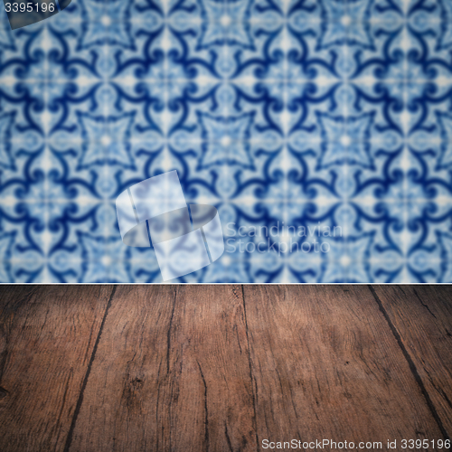 Image of Wood table top and blur vintage ceramic tile pattern wall