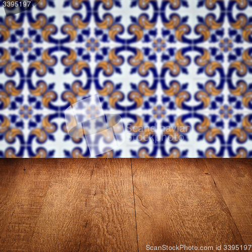 Image of Wood table top and blur vintage ceramic tile pattern wall