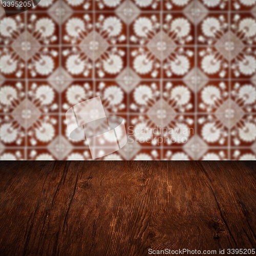 Image of Wood table top and blur vintage ceramic tile pattern wall