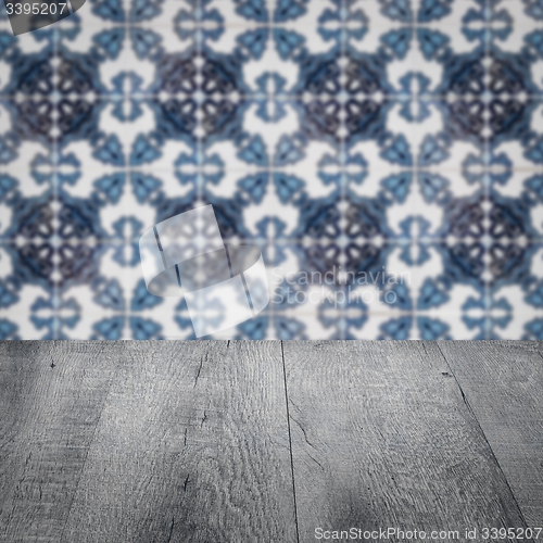 Image of Wood table top and blur vintage ceramic tile pattern wall