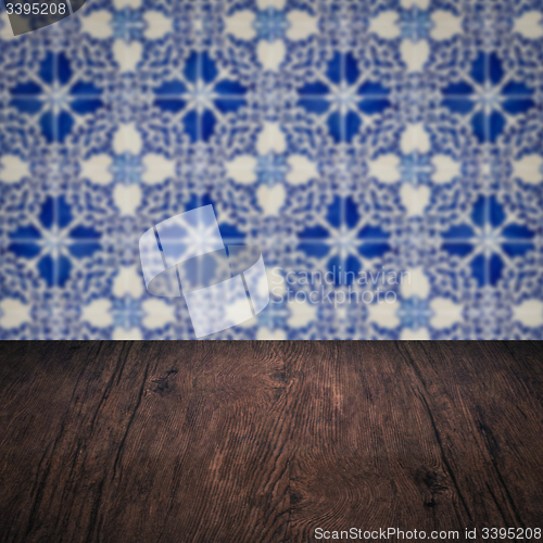 Image of Wood table top and blur vintage ceramic tile pattern wall