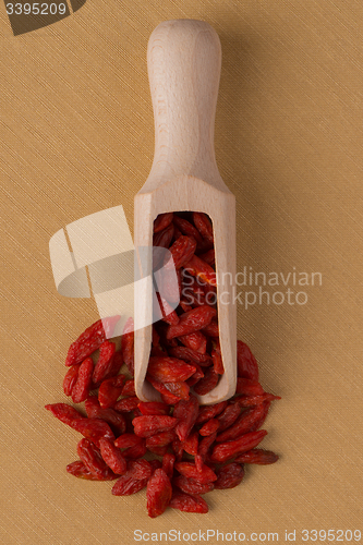 Image of Wooden scoop with dry red goji berries