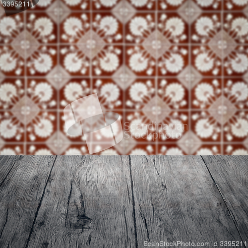 Image of Wood table top and blur vintage ceramic tile pattern wall