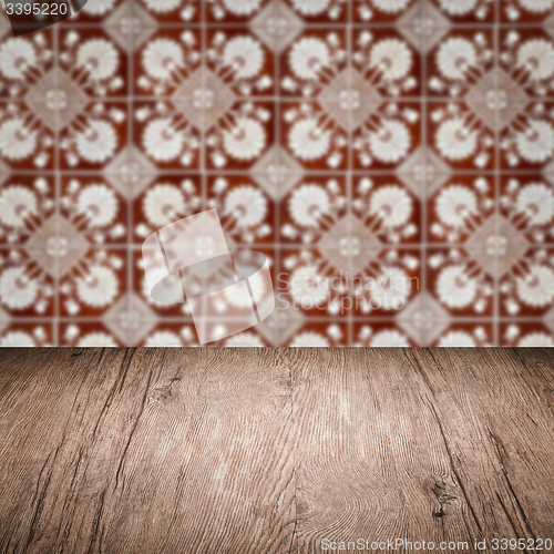 Image of Wood table top and blur vintage ceramic tile pattern wall