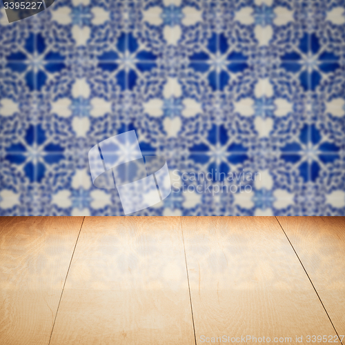 Image of Wood table top and blur vintage ceramic tile pattern wall