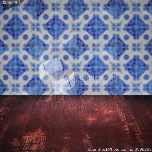 Image of Wood table top and blur vintage ceramic tile pattern wall