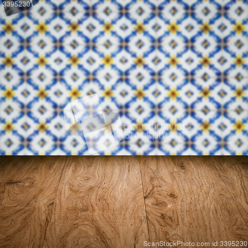 Image of Wood table top and blur vintage ceramic tile pattern wall