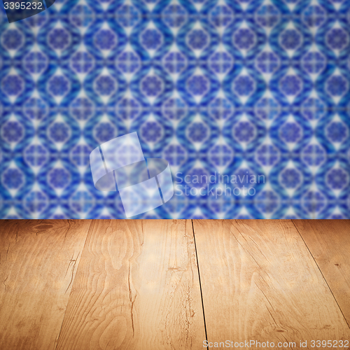 Image of Wood table top and blur vintage ceramic tile pattern wall