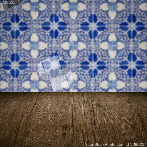 Image of Wood table top and blur vintage ceramic tile pattern wall