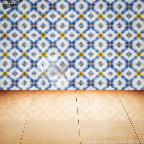 Image of Wood table top and blur vintage ceramic tile pattern wall