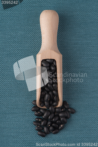 Image of Wooden scoop with black beans