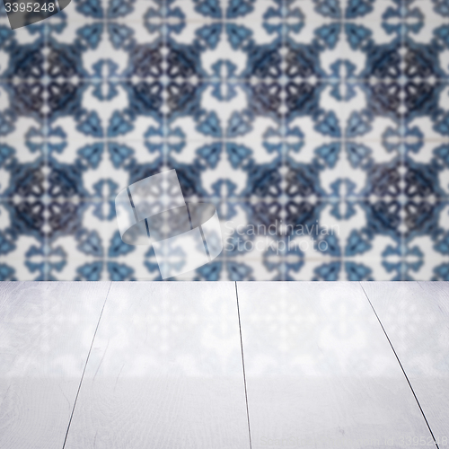 Image of Wood table top and blur vintage ceramic tile pattern wall