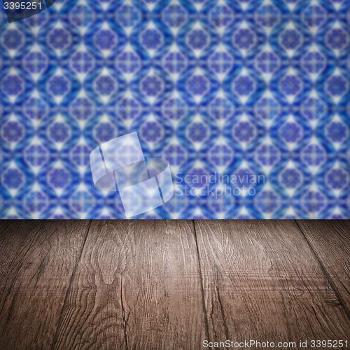 Image of Wood table top and blur vintage ceramic tile pattern wall