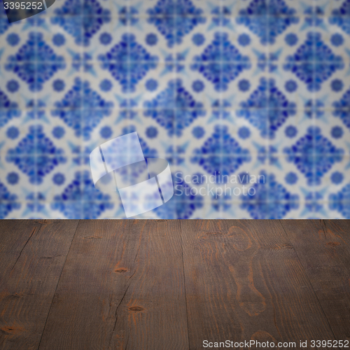 Image of Wood table top and blur vintage ceramic tile pattern wall