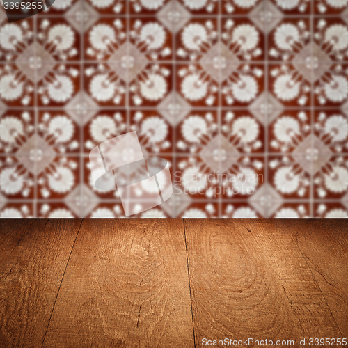 Image of Wood table top and blur vintage ceramic tile pattern wall