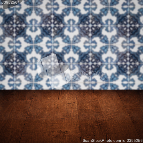 Image of Wood table top and blur vintage ceramic tile pattern wall