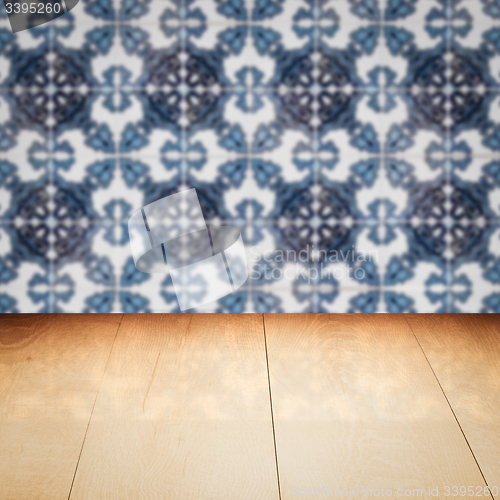 Image of Wood table top and blur vintage ceramic tile pattern wall