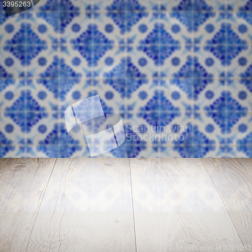 Image of Wood table top and blur vintage ceramic tile pattern wall