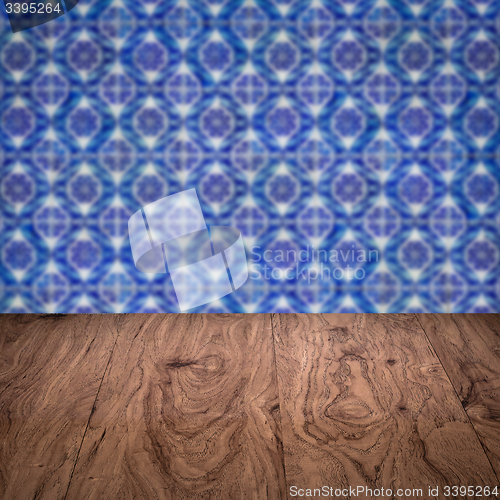 Image of Wood table top and blur vintage ceramic tile pattern wall